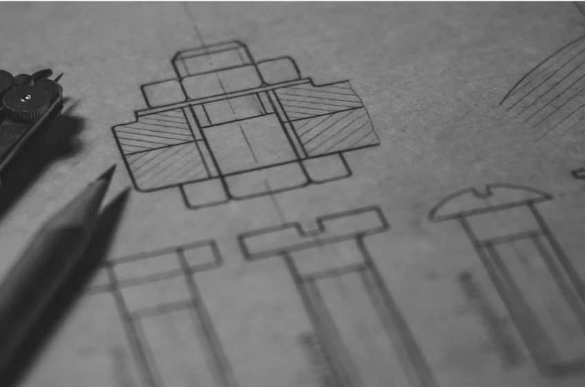 A black and white photo of a drawing with a pencil on it.