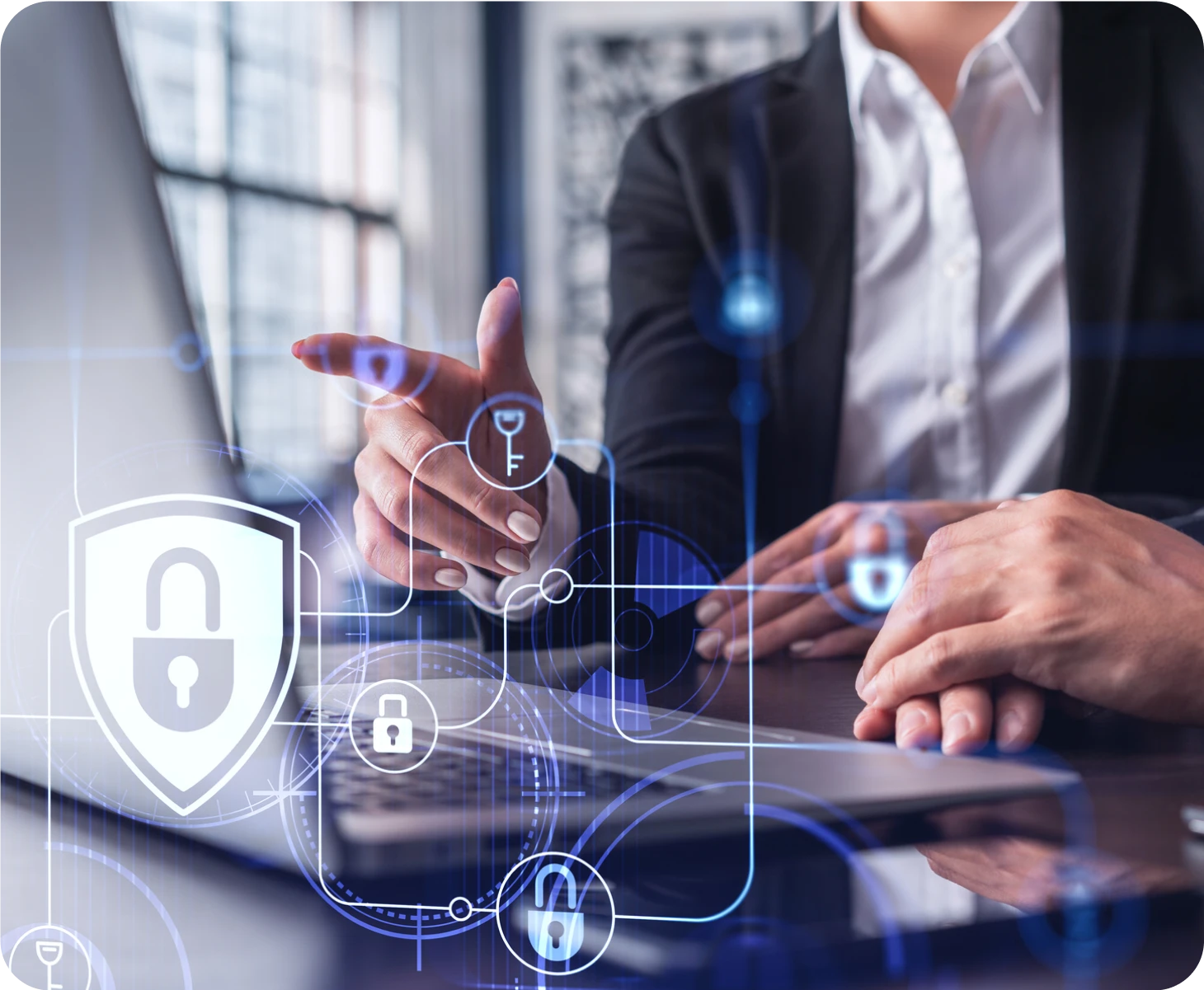 Two business people working on a laptop with a security symbol on it stock photo.